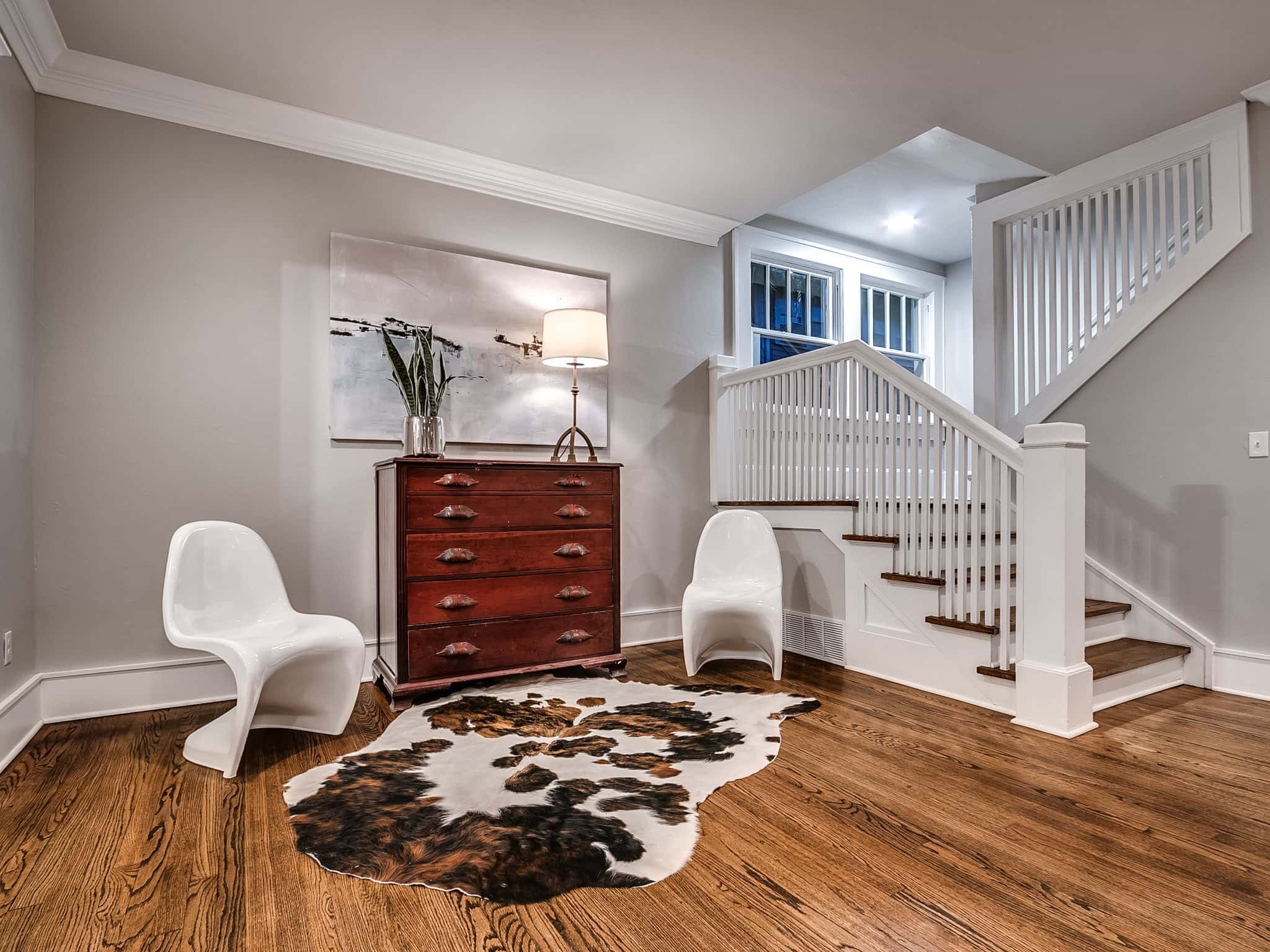 Custom hardwood flooring installation and staircase millwork in a Pasadena home foyer.