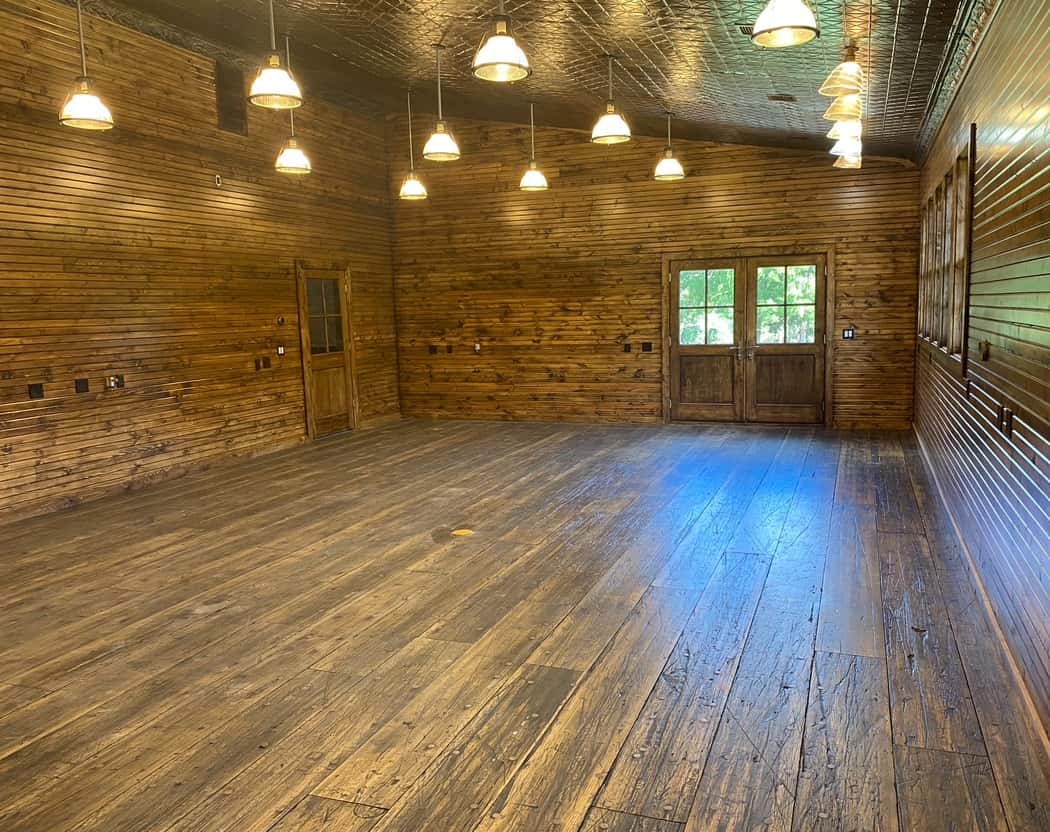 Full-scope commercial hardwood flooring installation and ceiling light feature.