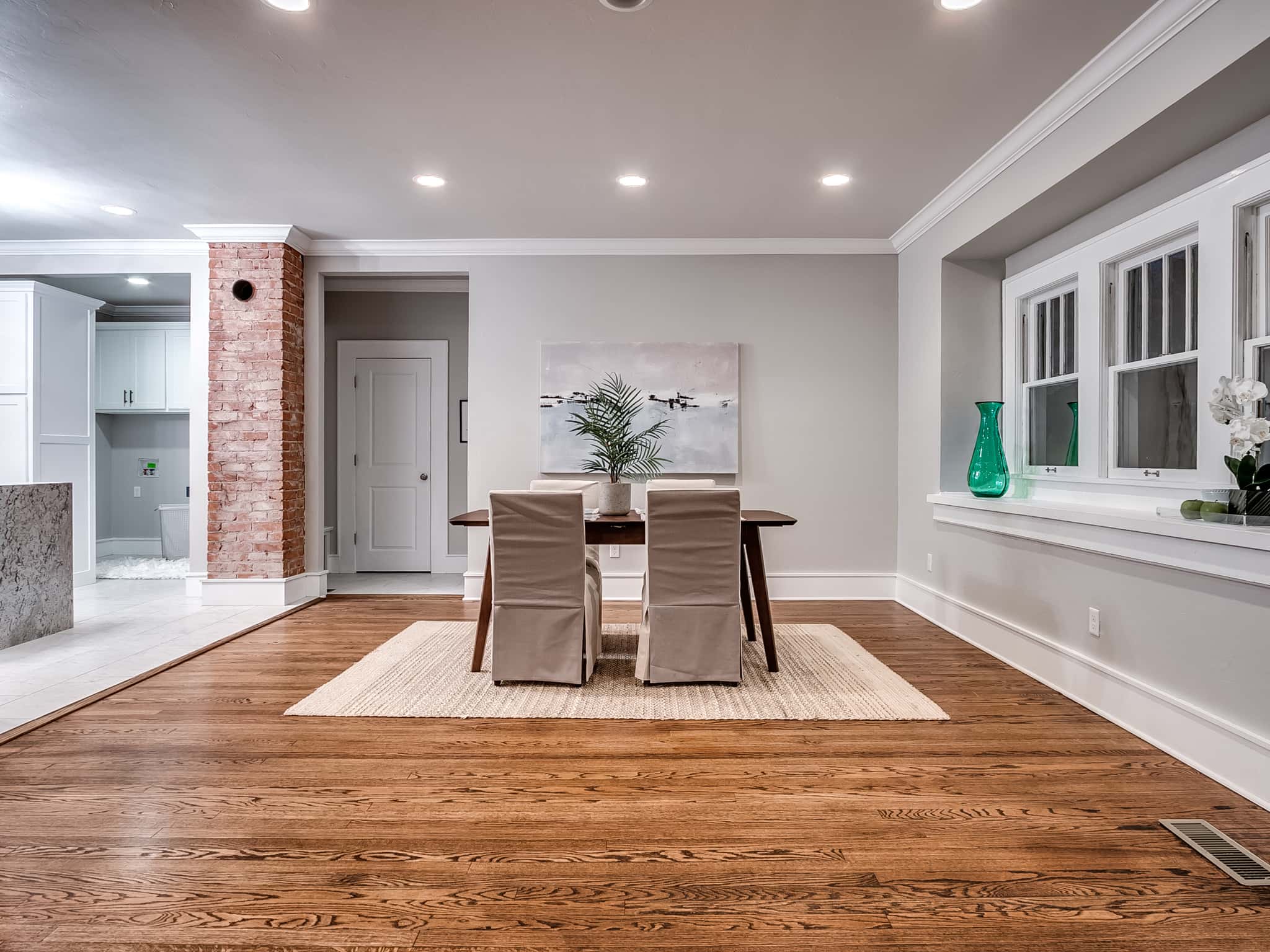 Interior home addition with open archway, custom wall paint, and hardwood flooring in Pasadena.